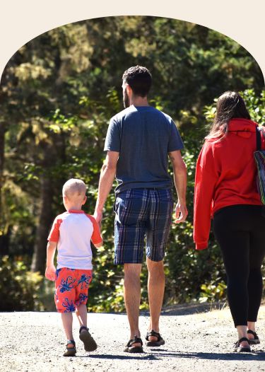 Family holding hands and walking away 